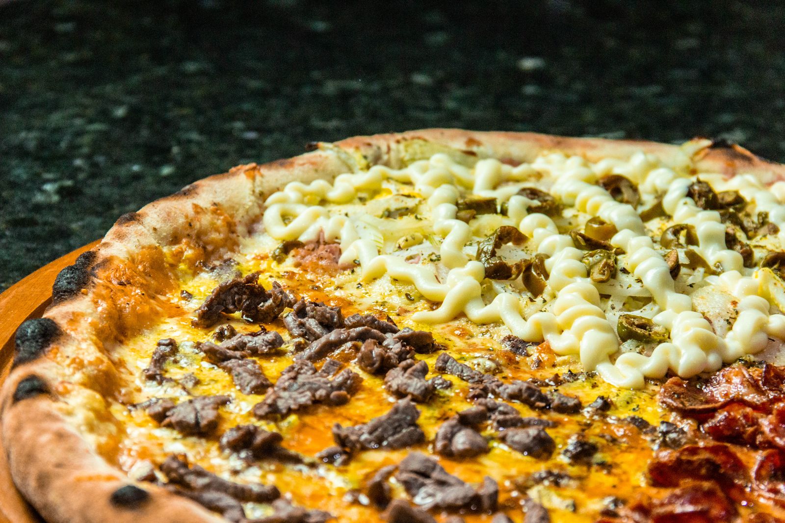 A half-pepperoni half-mushroom pizza fresh out of the oven