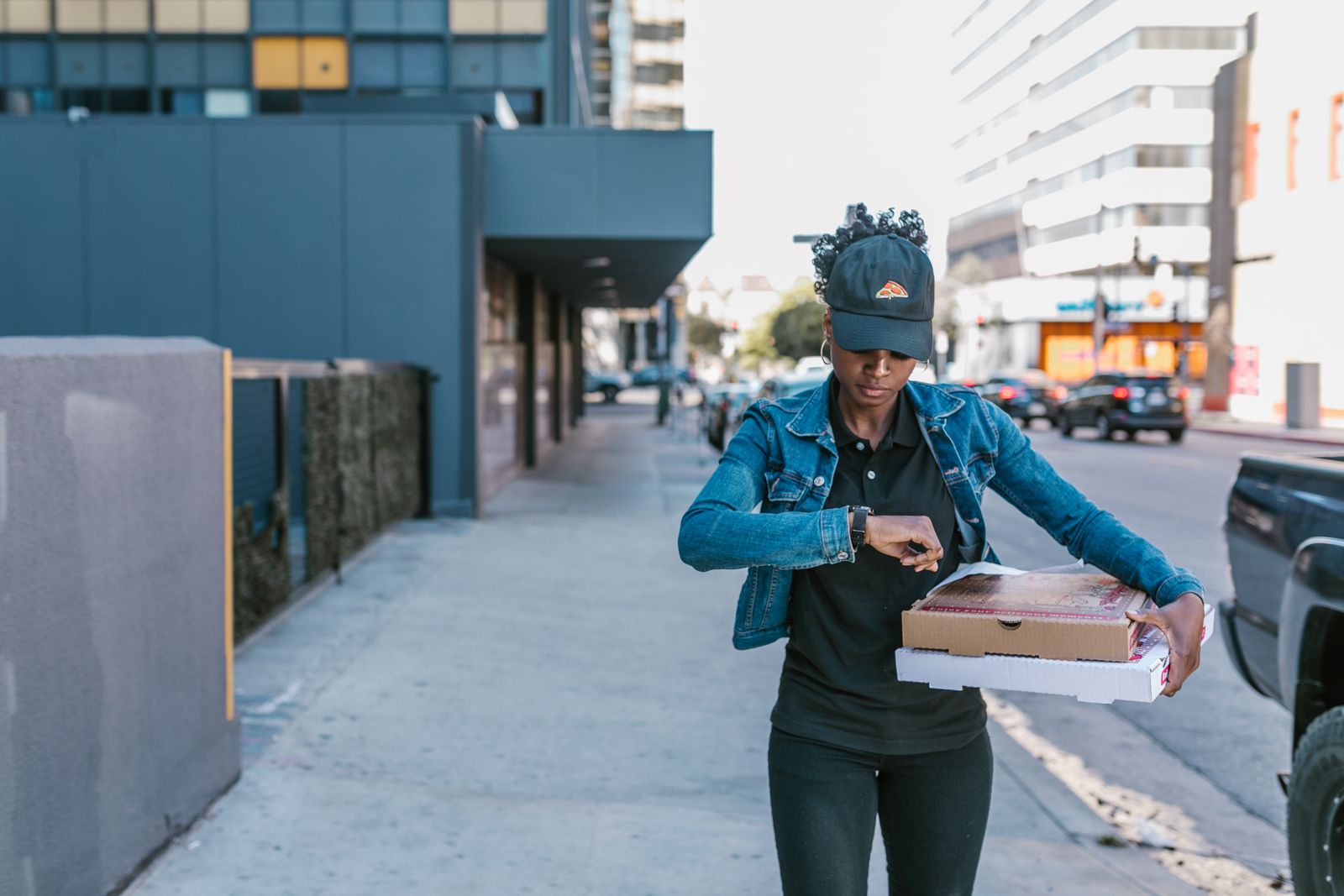 Pizza delivery driver handing a hot box to a customer at the door
